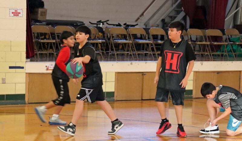 5th grade basketball players warm up before the game.